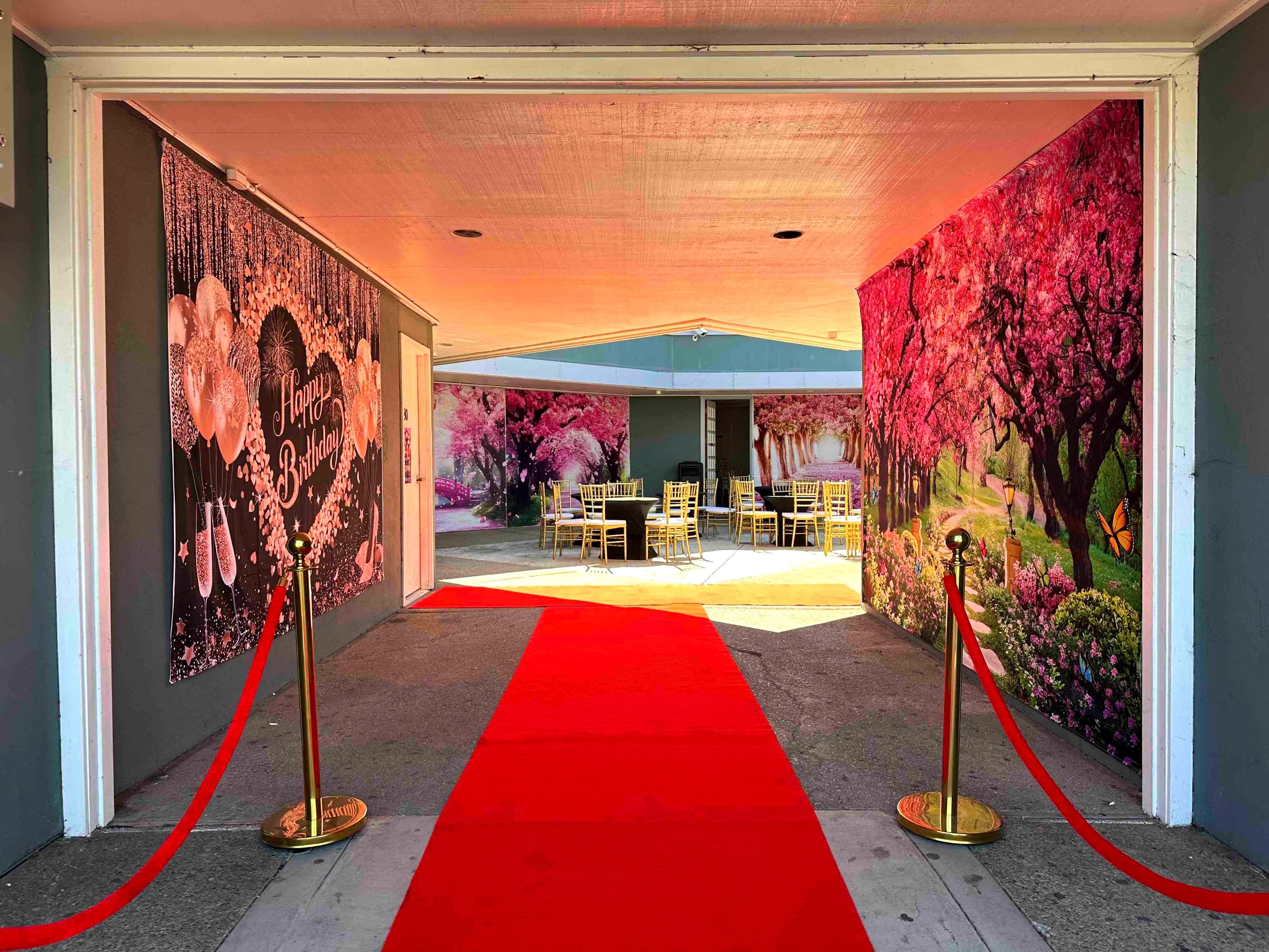 Alvin open-air courtyard set with gold chiavari chairs and floral backdrops